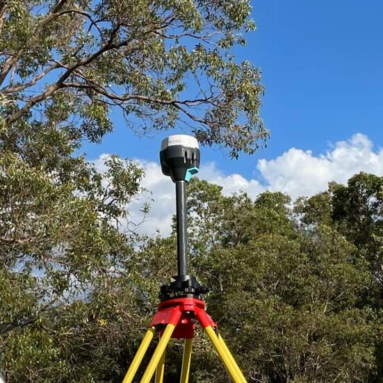 Drone surveying using high-precision RTK GPS equipment for land measurement and data collection during a site survey, ensuring accurate geospatial positioning.