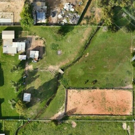High-resolution orthomosaic image showing rural properties, paddocks, and power infrastructure captured during a drone surveying for mapping and land analysis.