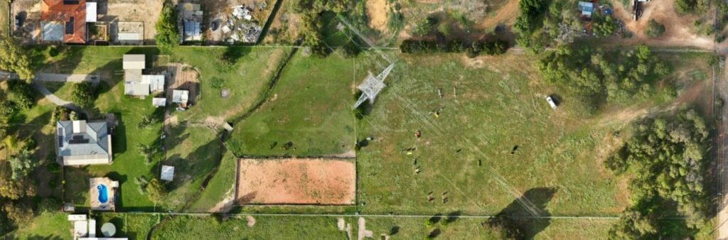High-resolution aerial image showing rural properties, paddocks, and power infrastructure captured during a drone survey for mapping and land analysis.
